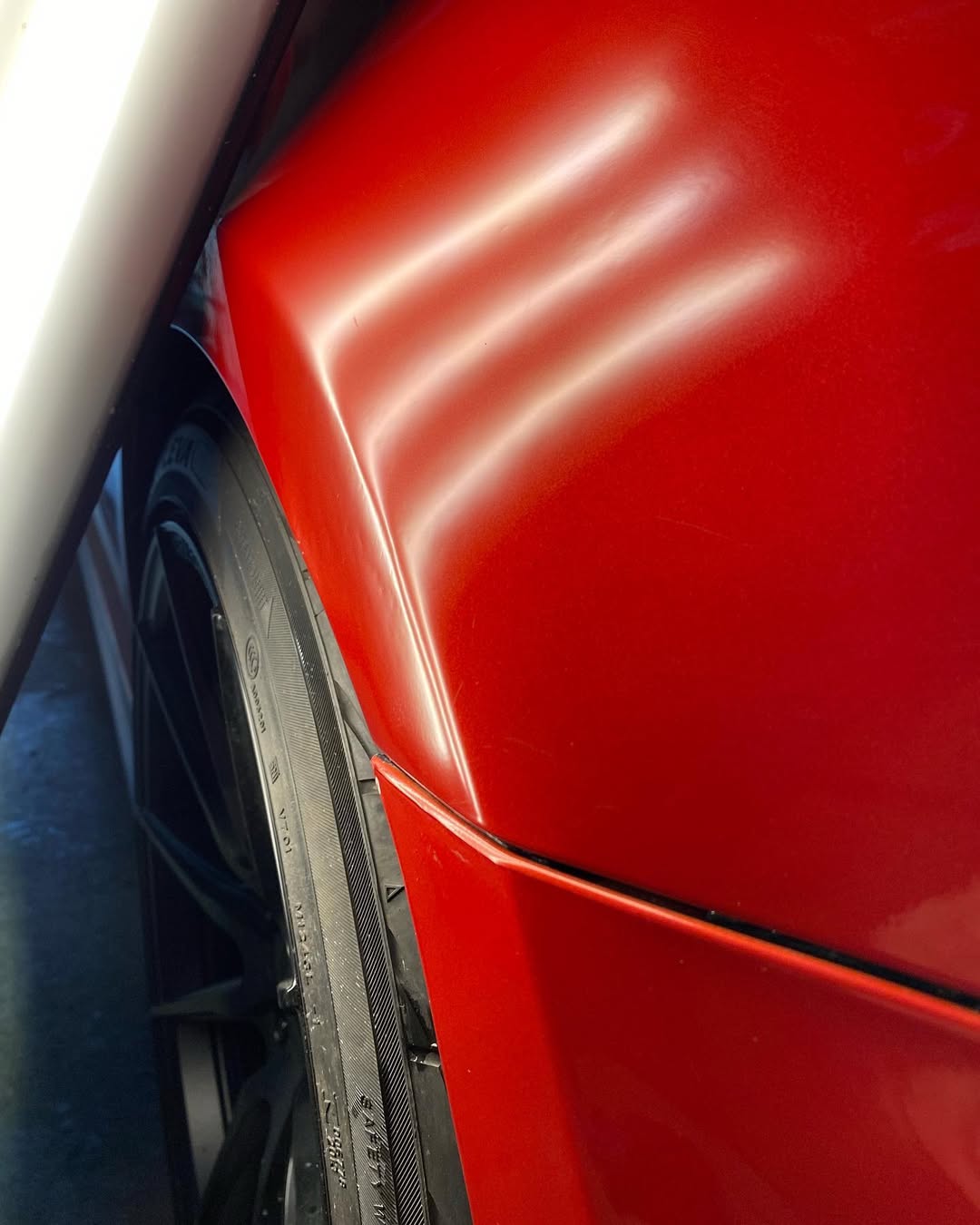 Red car door with scratched paint