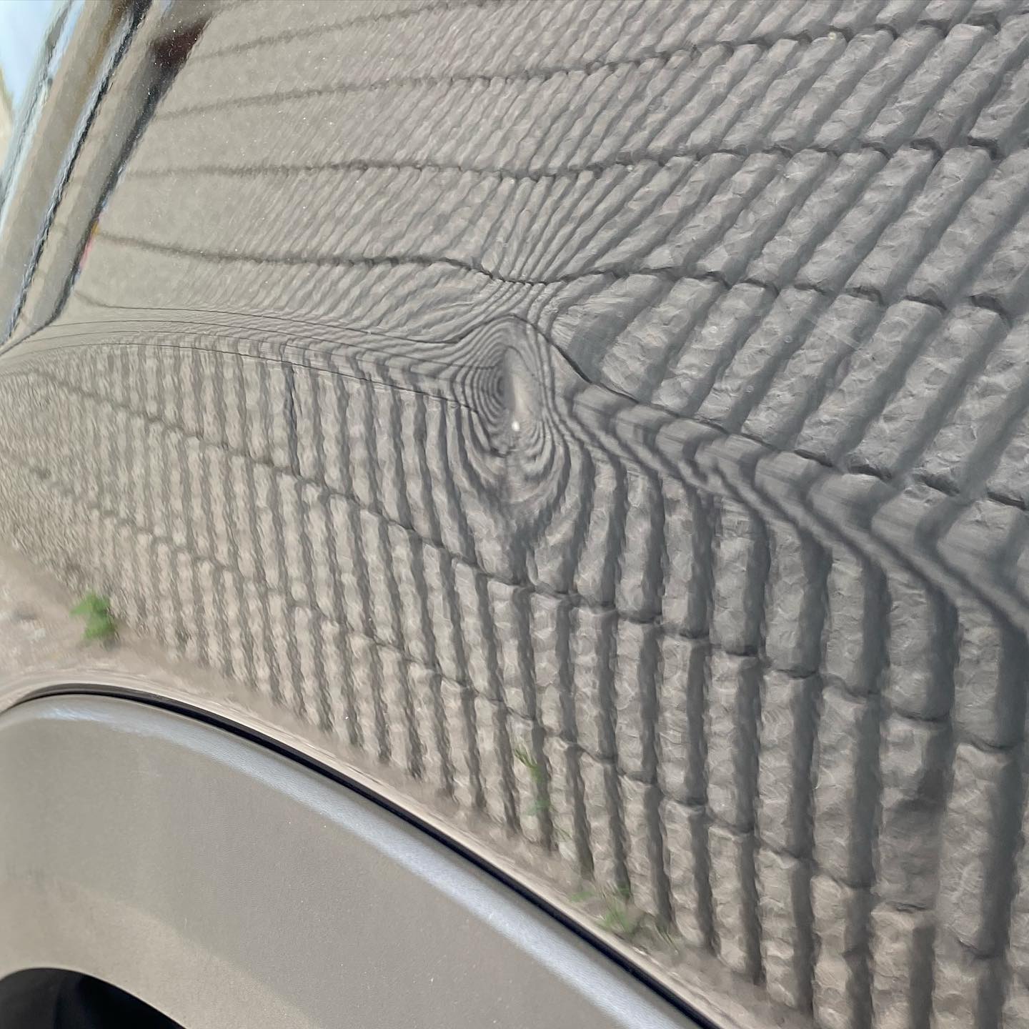 Light gray silver car hood with scratches