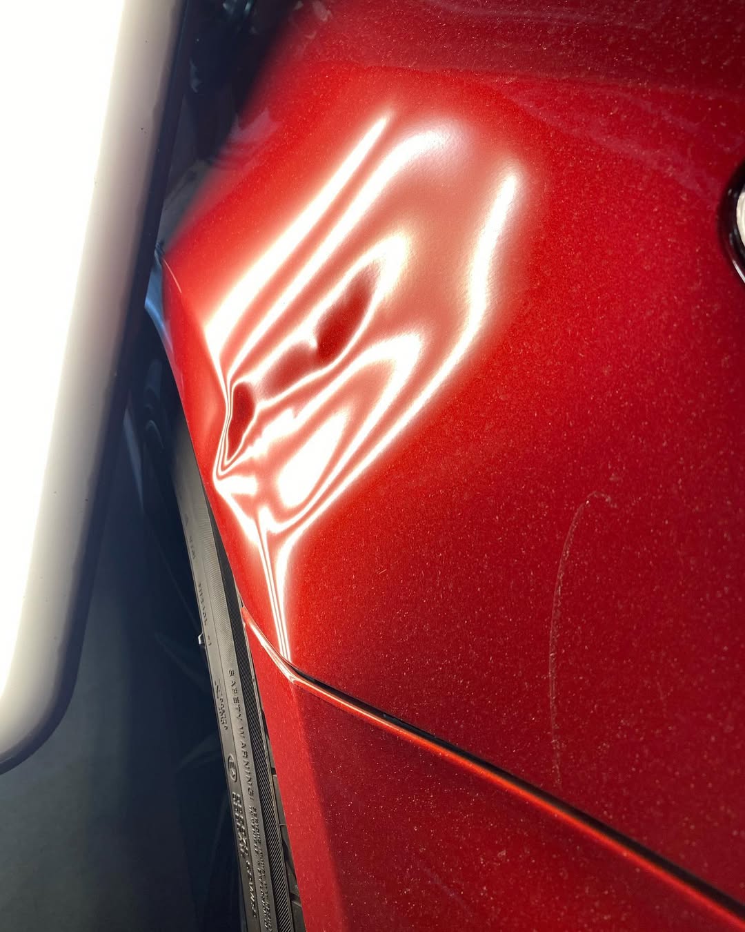 Heavily scratched dark metallic gray car door