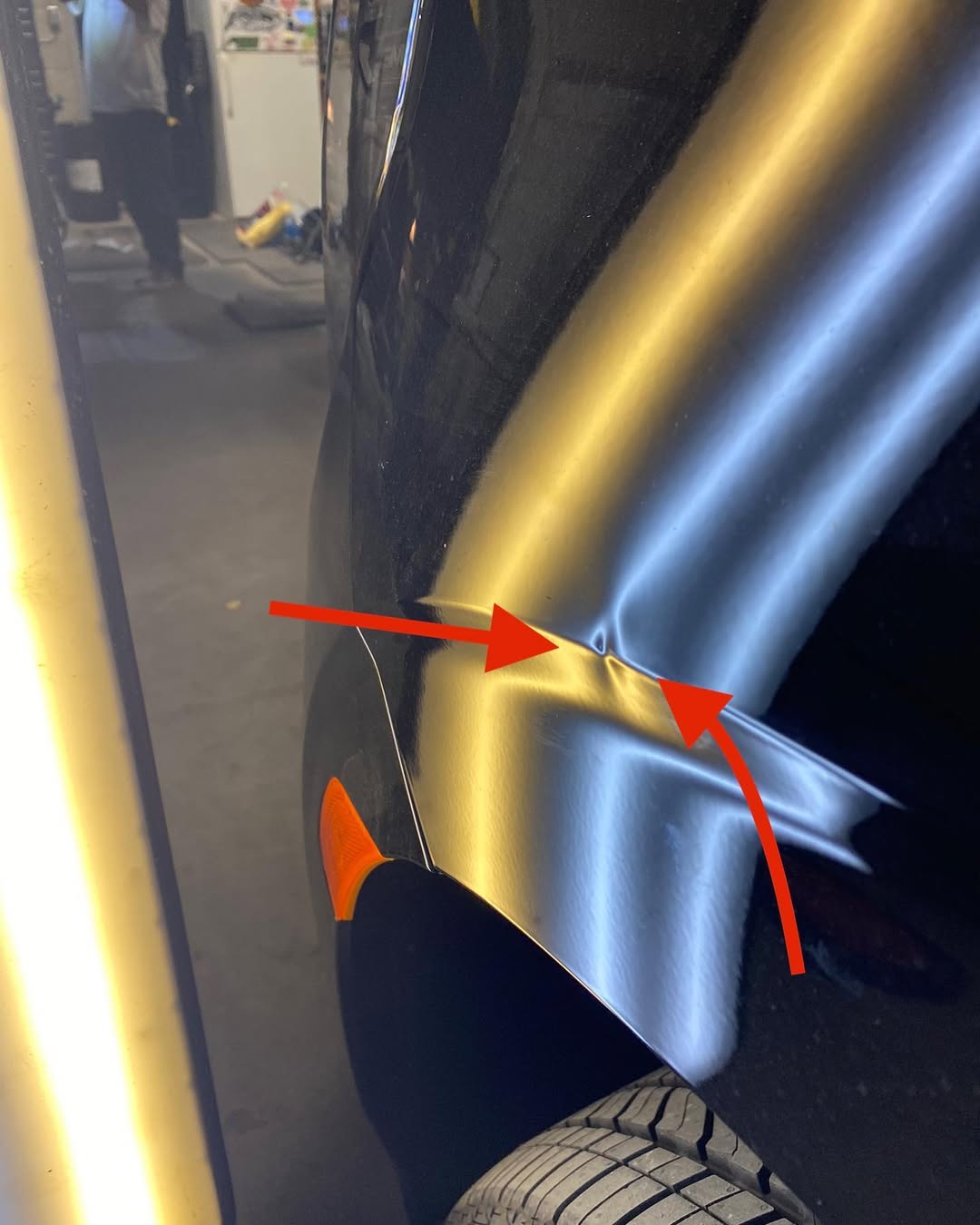 Dark green car panel with scratch