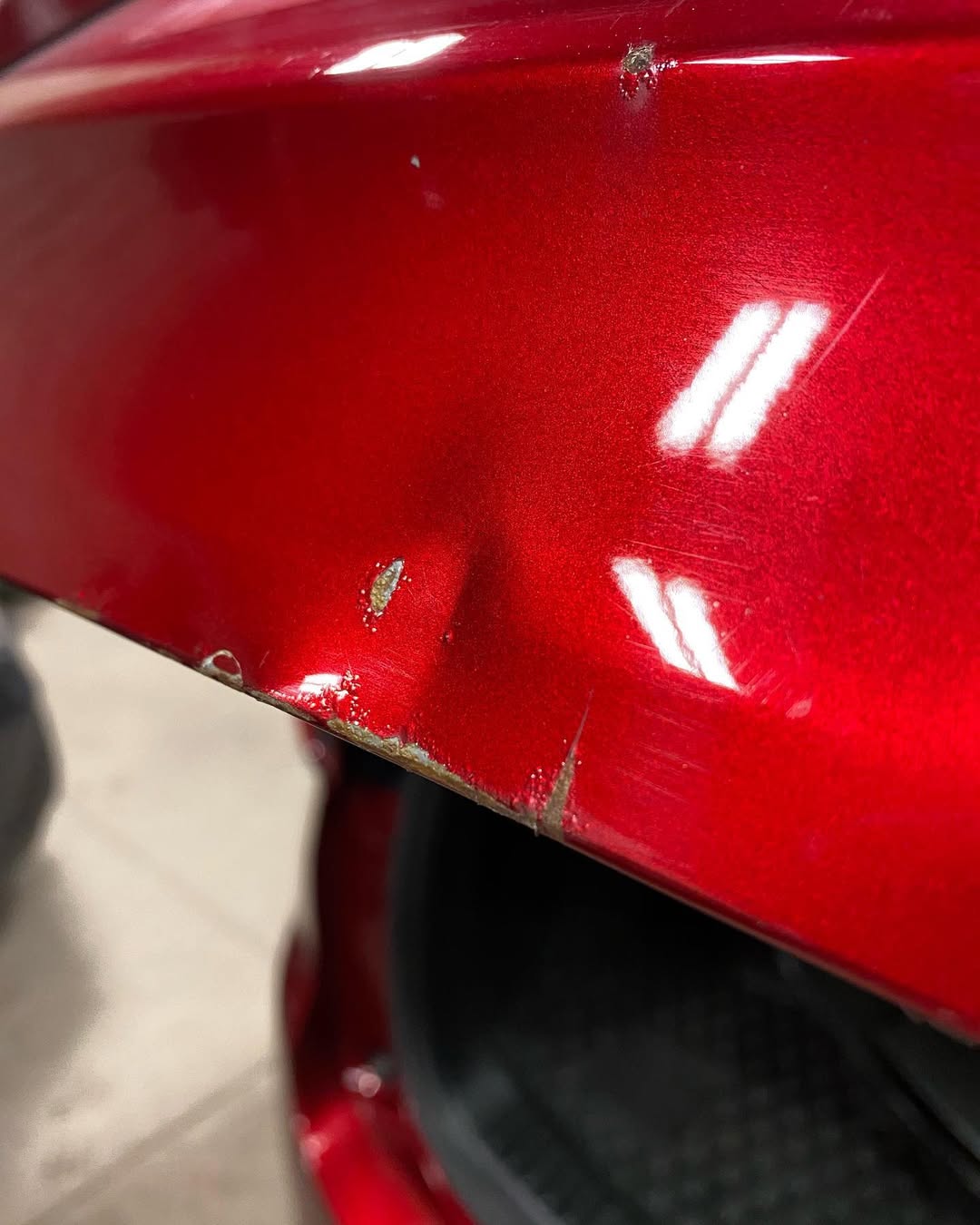 Wet shiny red car surface with water droplets